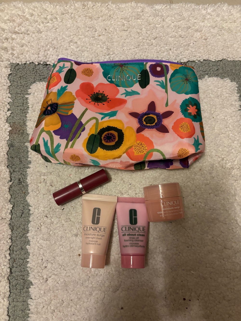 Clinique Floral Pink Cosmetic Bag with Pink Skincare & Red Lipstick